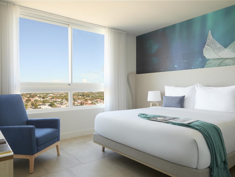 King bed with white sheets and side table