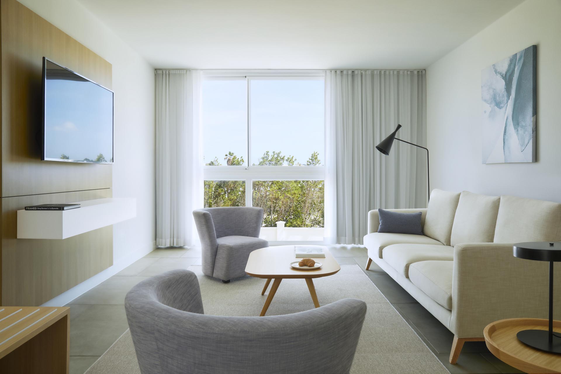 Living room with a sofa and a wall-mounted TV