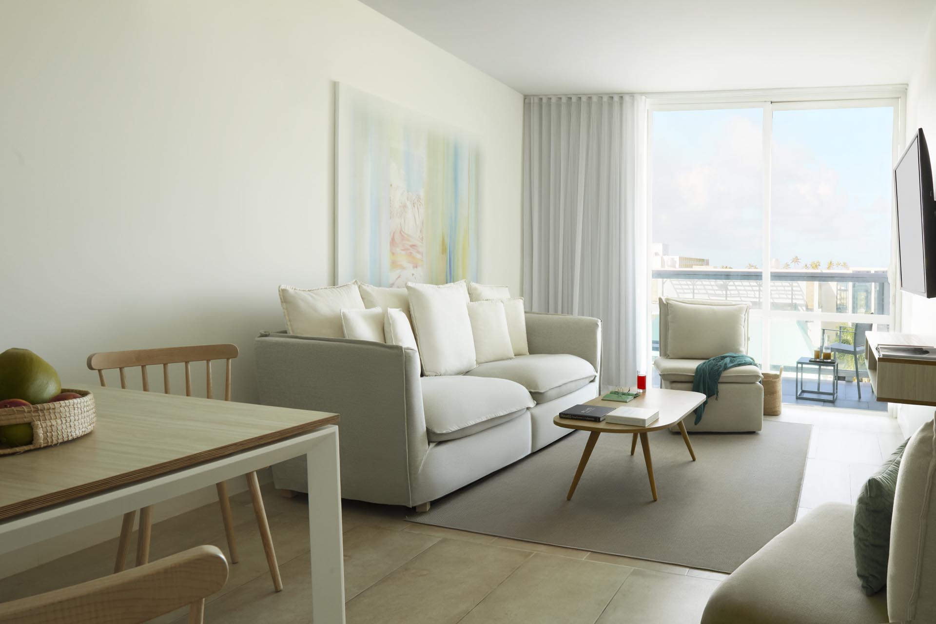 Lounge area in living room with chairs and mounted TV