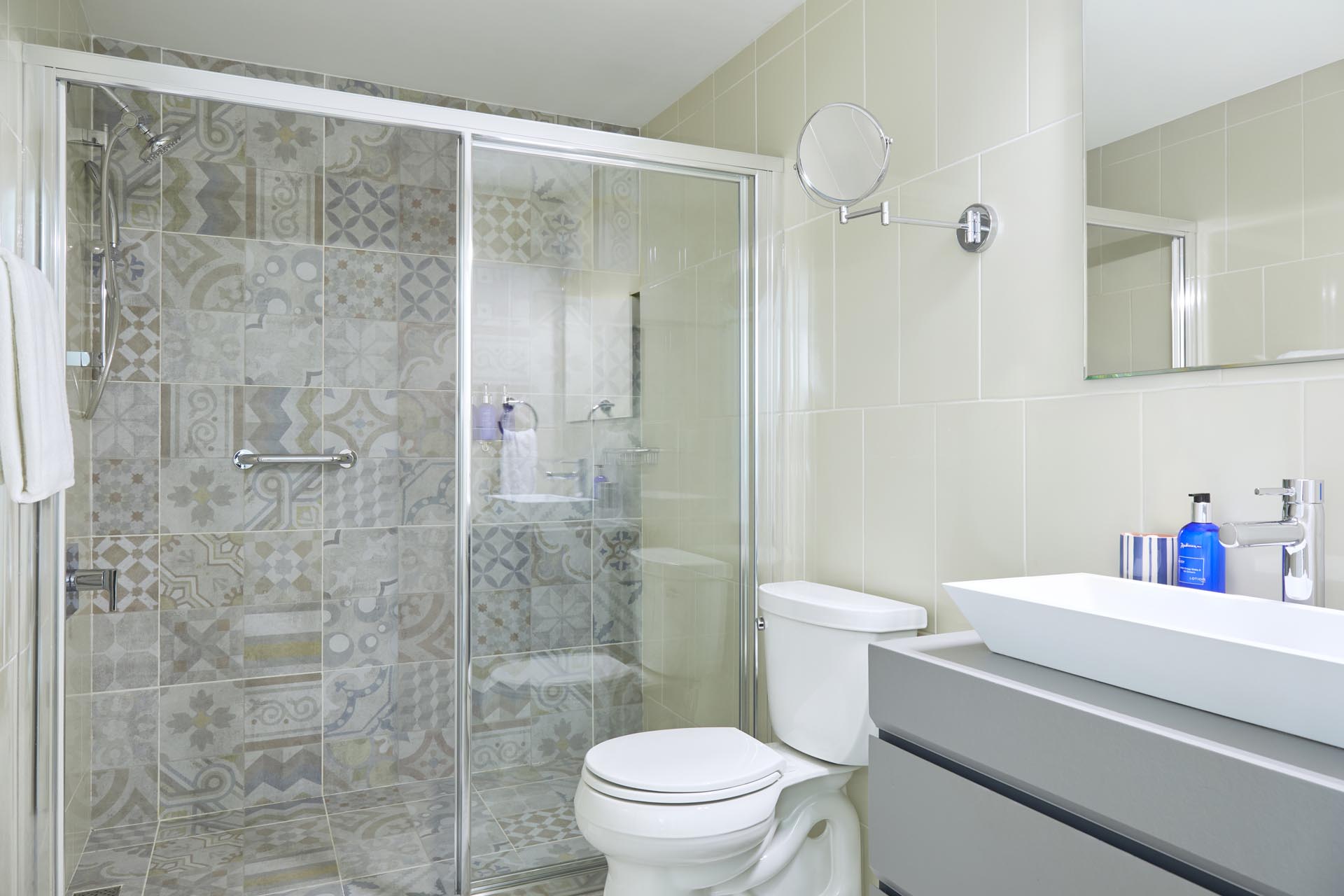 bathroom with vanity, shower, and toilet