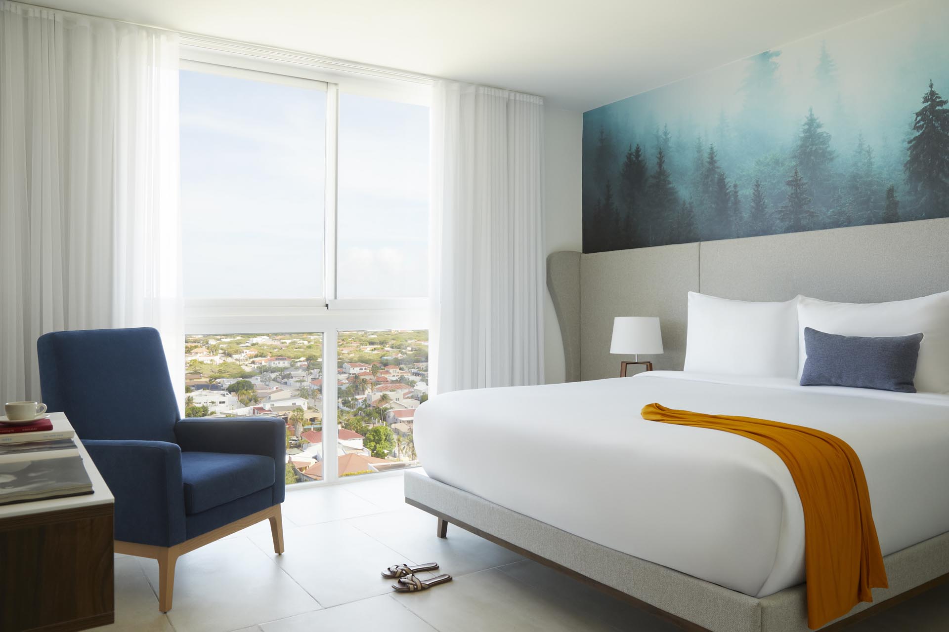 King bed with side tables and blue artwork on wall