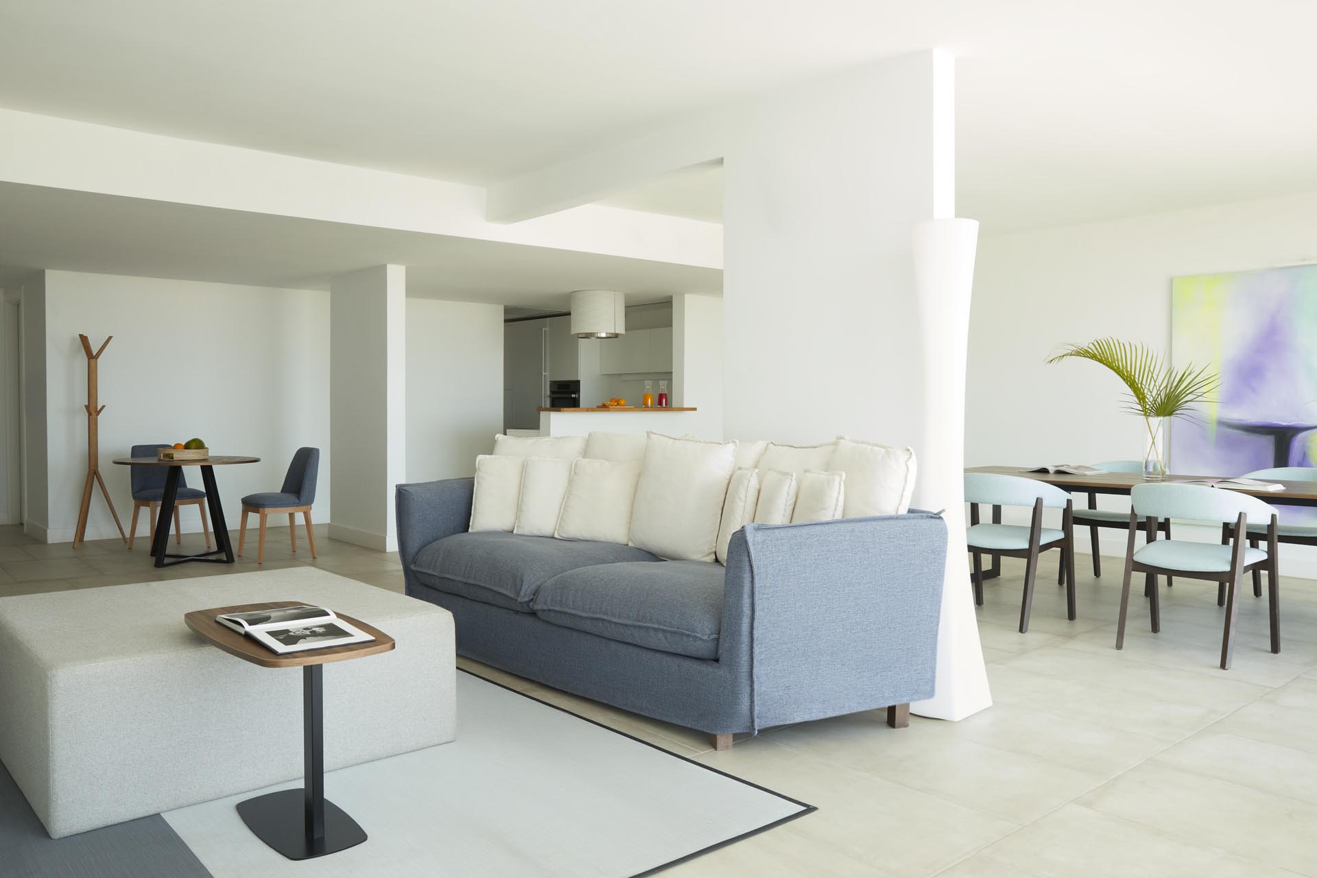 Dining table and lounge area with couch and mounted TV