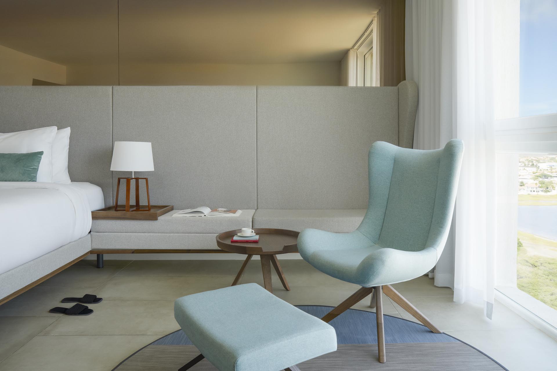 Seating area with bed and large windows