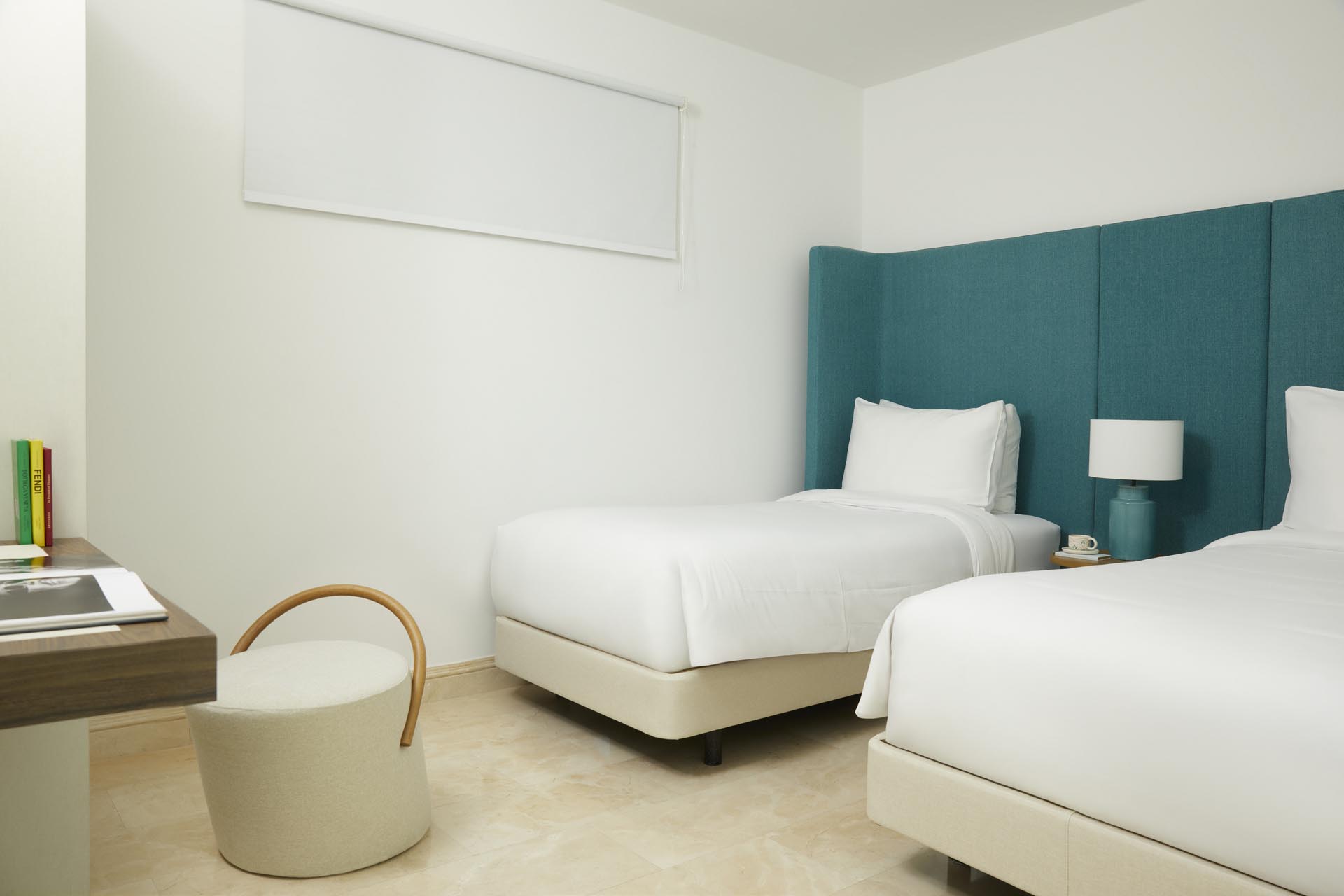 Two twin beds with mounted TV